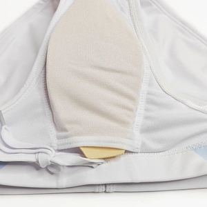 Detail of internal pocket with removable padding on white men's swim trunks