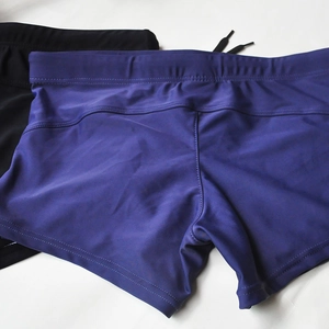 Detail of men's swimming trunks with elastic fabric texture and adjustable drawstring