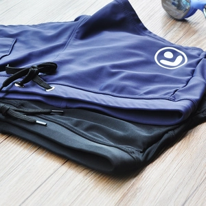 Detail of men's swim trunks featuring a secure drawstring waist and side logo design