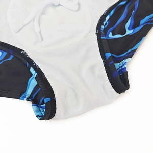 Detail view of men's swim trunks featuring blue flame print and white mesh lining