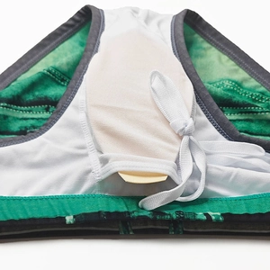 Detail of green printed swimwear showing the inner padding pocket and removable cup