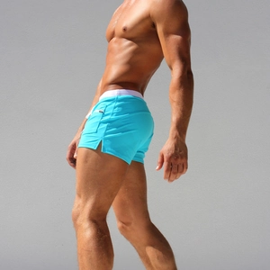 Detail of blue men's swim trunks featuring a side zipper pocket and elastic waistband