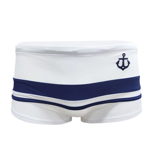 Men's low-waist boxer swim trunks in white with dark blue nautical anchor pattern