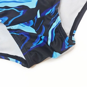 Detail of blue and black abstract printed swimwear fabric with double-needle stitching