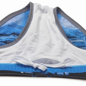 Detail of men's denim print swim briefs featuring white inner lining and waist drawstring