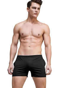 Close-up of black modal boxer shorts with white waistband on an athletic male model