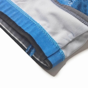 Close-up of quick-dry denim print swim briefs featuring breathable mesh and flat seams