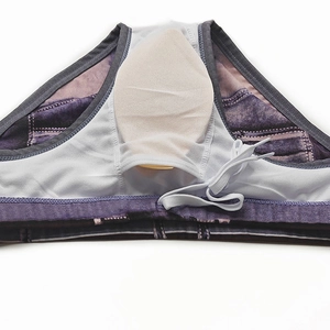 Detail of purple denim print swim trunks showing removable white sponge padding and drawstrings