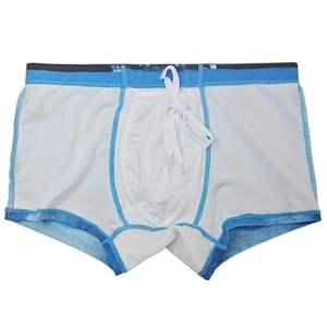 Detail of men's quick-dry swim trunks featuring blue tie-dye edges and drawstring waist