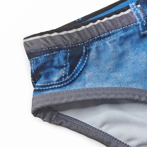 Close-up of quick-dry swim briefs with realistic denim print and gray elastic edges