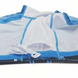 Detail of men's denim print swim trunks showing U-convex lining and white drawstring