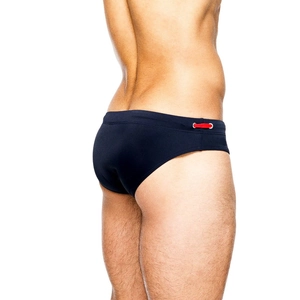 Detail view of men's low-rise swim trunks in dark blue with red side drawstrings