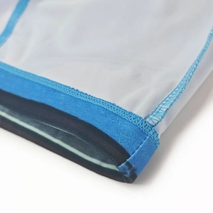 Macro shot of high-elastic blue piping and professional stitching on white swim trunks