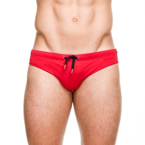 Men's solid red competitive swim briefs with black drawstring and metallic tips for beach