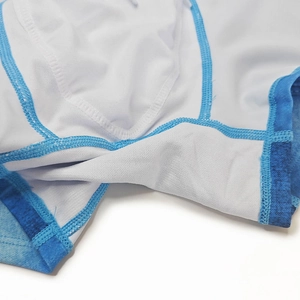 Close-up of double-layered reinforced crotch and contrast stitching on denim print trunks