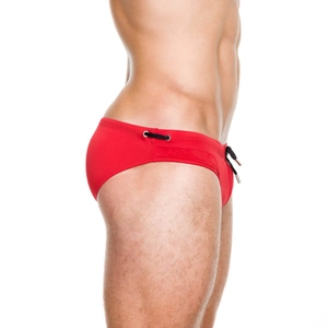 Detail of red men's swim briefs featuring black drawstring and metallic eyelets