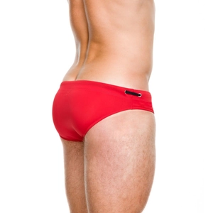 Detail view of red men's tight swimming briefs with side drawstring and metal eyelet