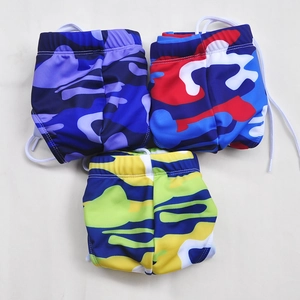 Detail view of multi-color camo swimming trunks with elastic waistband and white drawstrings