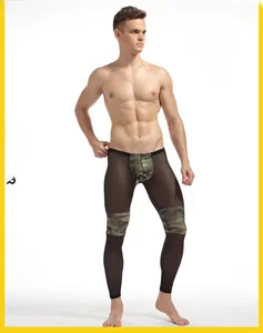 Detailed view of men's sheer black mesh pants with camouflage patchwork design