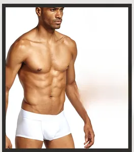 Close-up of white cotton boxer briefs showing elastic waistband and brand logo detail