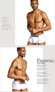 Detailed view of men's white cotton boxer briefs with a wide elastic logo waistband