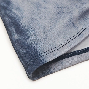 Close-up of quick-dry swim trunks featuring denim print fabric and breathable mesh lining