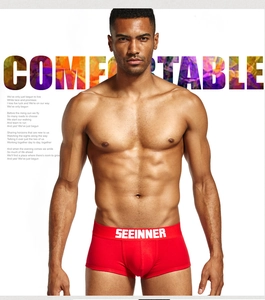 Close-up of men's red cotton boxer briefs showing branded waistband and fit