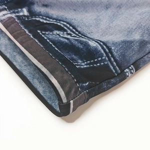 Close-up of quick-dry swim trunks with realistic blue denim print and faux stitching