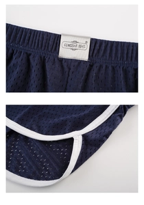 Detail of navy blue ice silk mesh fabric with elastic waistband and white contrast piping