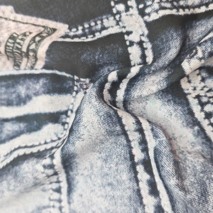 Macro detail of quick-dry swim trunks fabric with denim print and decorative stitching