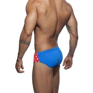 Detailed side view of men's star print swimming briefs with red and white athletic patterns