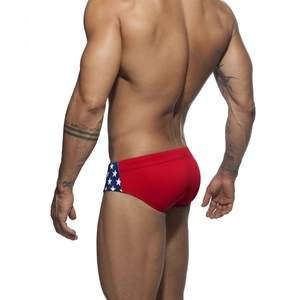 Rear view detail of men's athletic swim briefs with star pattern and red stretch fabric