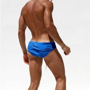 Rear view of men's bright blue nylon swim briefs with elastic quick-dry fabric