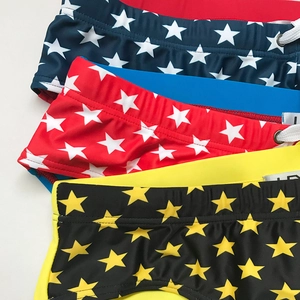 Detailed view of elastic men's swim briefs with star patterns and drawstring waistbands