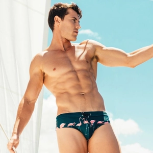 Men's dark green swim briefs with pink flamingo print and adjustable drawstring waist