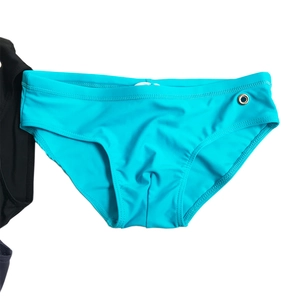 Detail of bright cyan men's swim briefs with elastic waistband and white drawstring