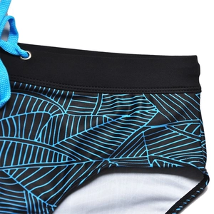 Detail of men's swim briefs featuring black elastic waistband and blue drawstring ties