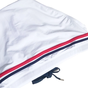 Close-up of white swim briefs showing red and blue stripe detail and navy drawstring