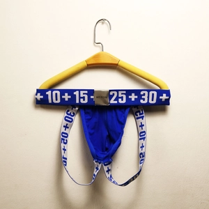 Detail of blue men's cotton jockstrap with numerical print and silver waist tag