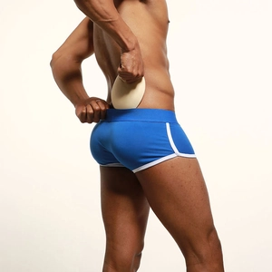 Detail of royal blue men's underwear with removable foam padding for butt lifting effect