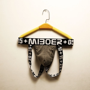 Macro shot of grey cotton jockstrap showing wide elastic waistband with M1B0ER logo