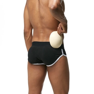 Detail view of removable padded hip lifting inserts on men's functional briefs