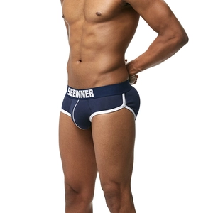 Detail view of navy blue low-rise men's briefs with white elastic waistband and seam trim