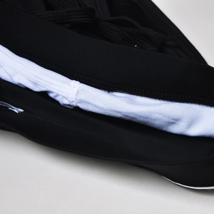 Macro shot of men's black swim briefs featuring dual-layer fabric and adjustable drawstring