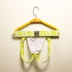 Detail of white cotton jockstrap with neon yellow elastic bands and printed numbers