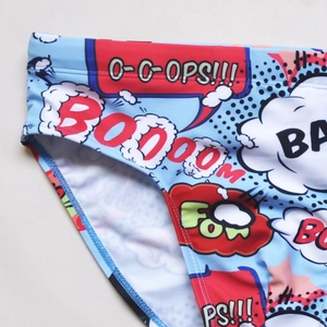 Macro shot of men's blue swim briefs featuring pop art comic prints and stitching details
