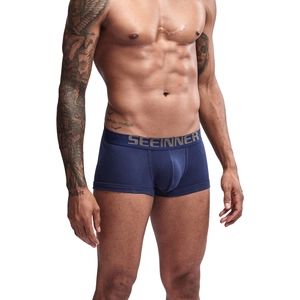 Detailed view of dark blue cotton boxer briefs with a wide elastic logo waistband