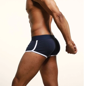 Detail of navy blue men's trunks with white piping and wide elastic waistband