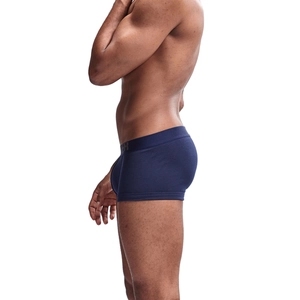 Side view of navy blue cotton boxer briefs with elastic waistband on male model