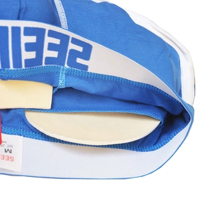 Detail view of men's cotton boxers showing the removable beige foam cup padding insert